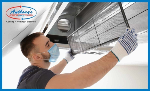 Man replaces filter on HVAC system